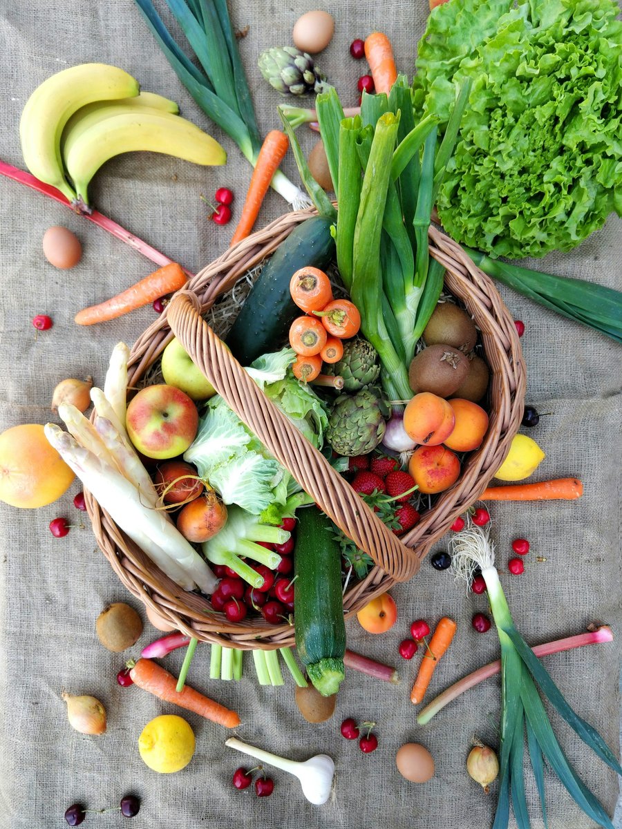 Panier de légumes et de fruits de saison posé sur une toile de lin